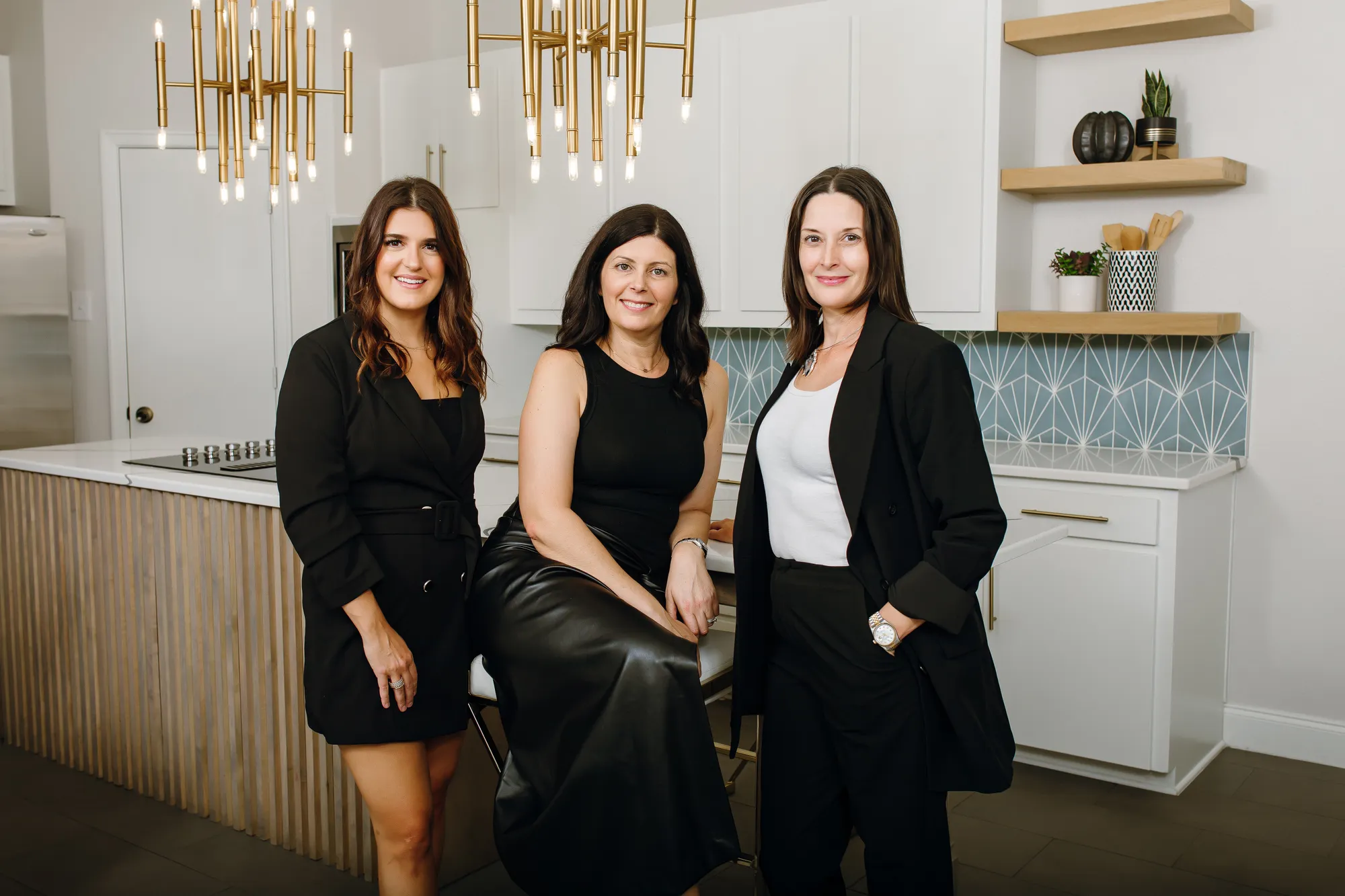 Two women posing for a picture in a kitchen.