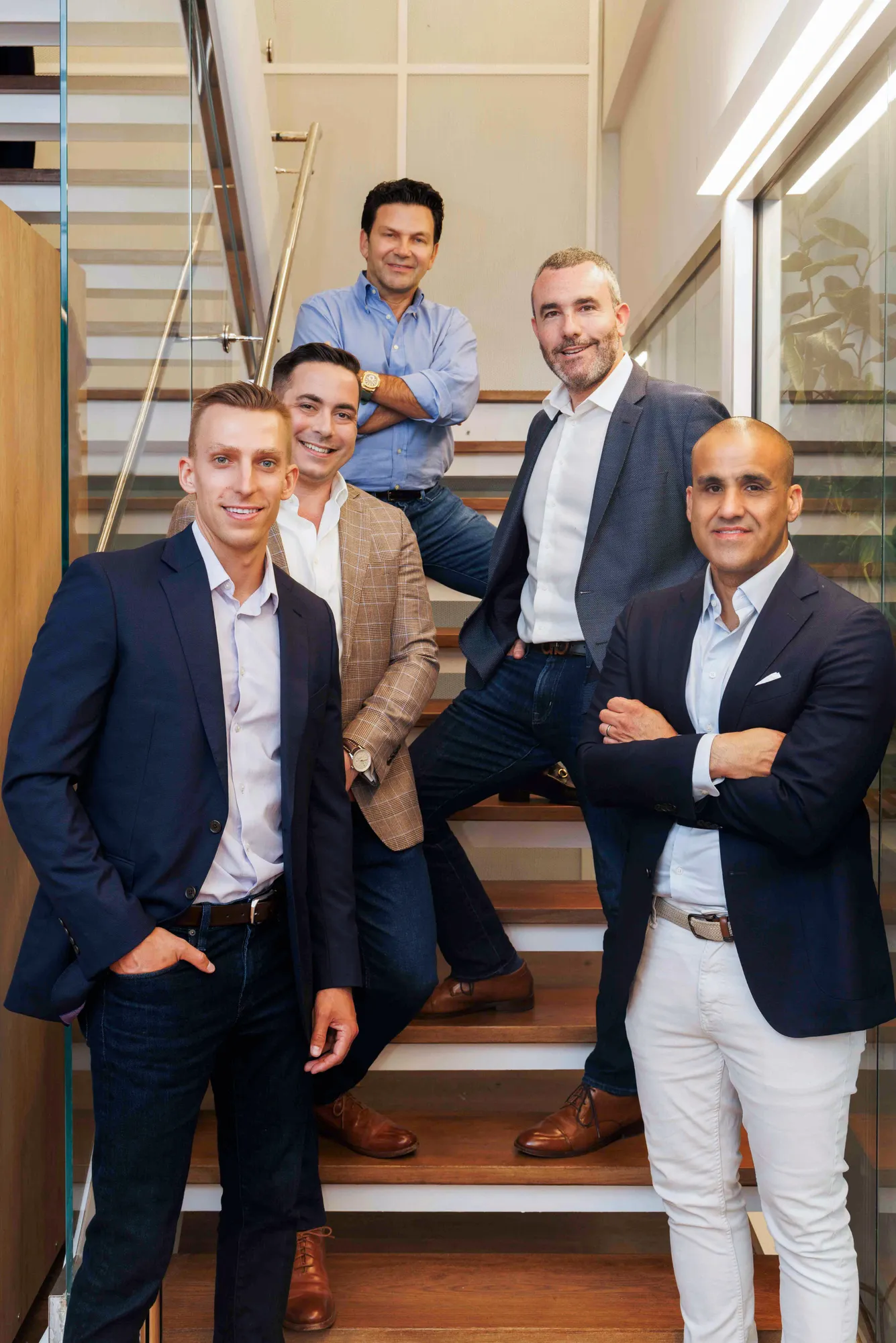 The image likely shows men standing on a stairway.