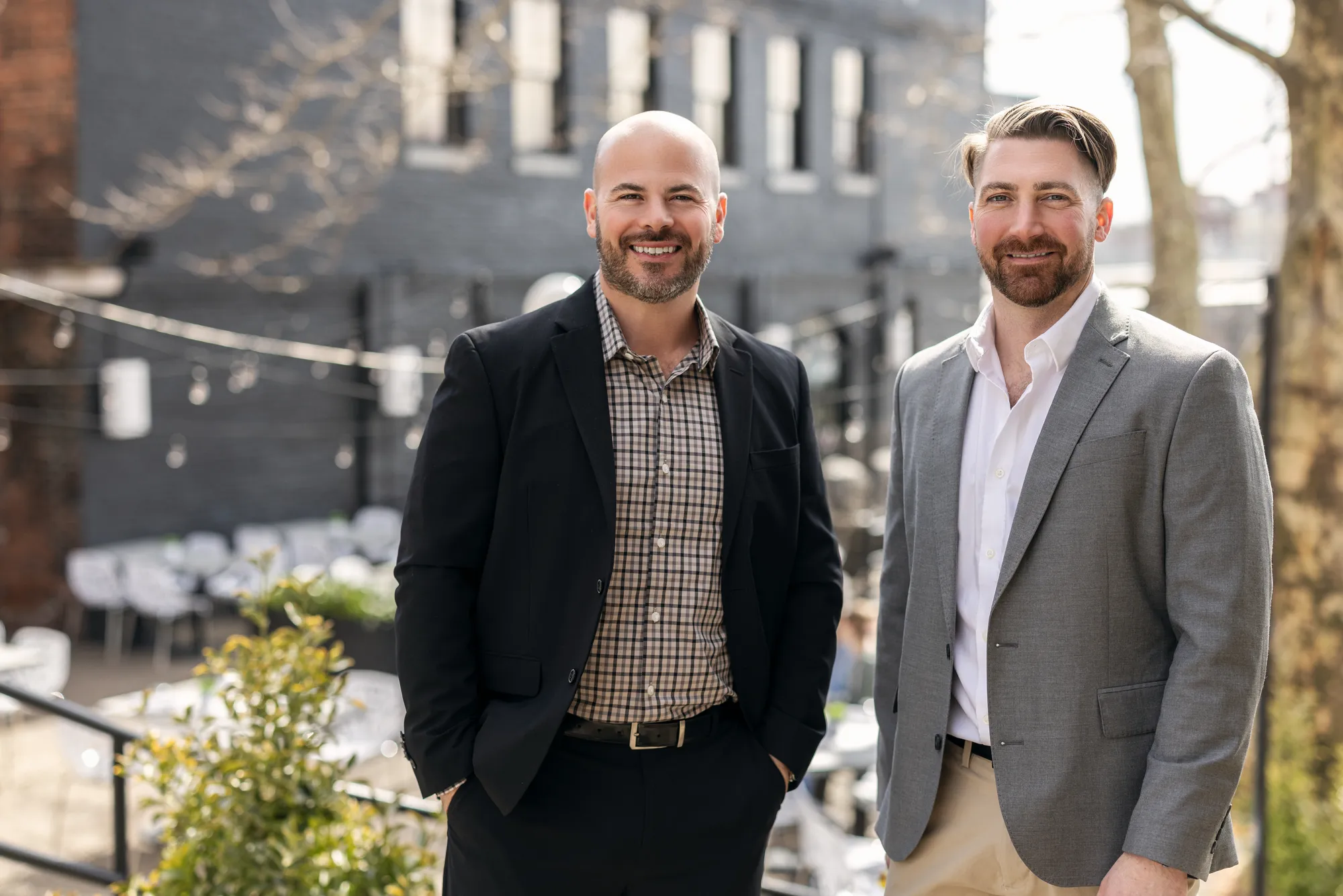 Two men in suits standing next to each other