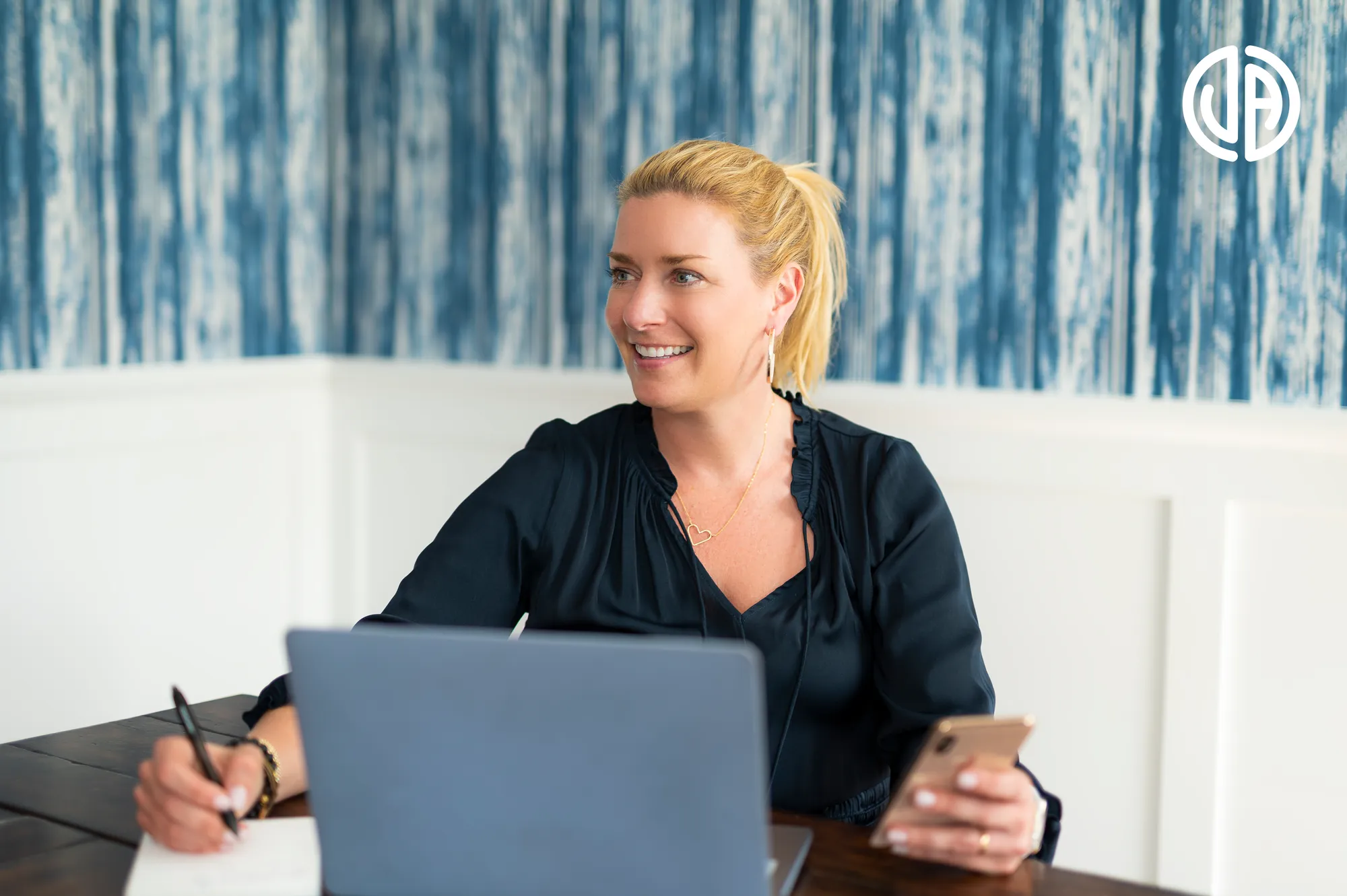 A woman sitting at a table with a laptop