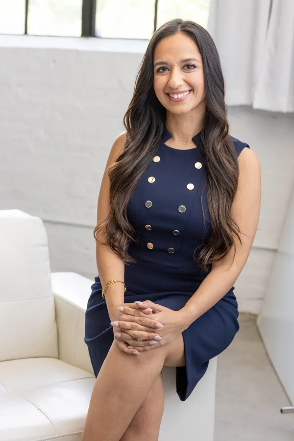 Rose Ibrahim, Austin real estate agent, seated and smiling.