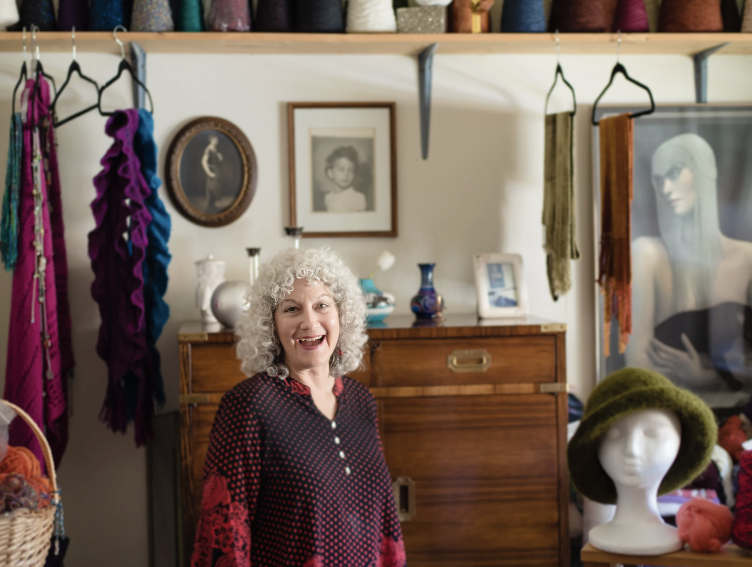 a woman standing in a room with a bunch of things