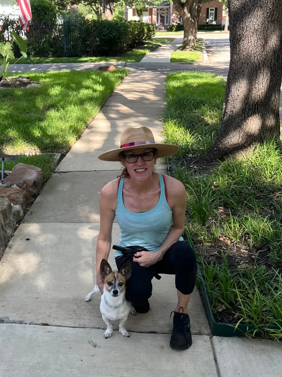 a woman holding a dog on a leash