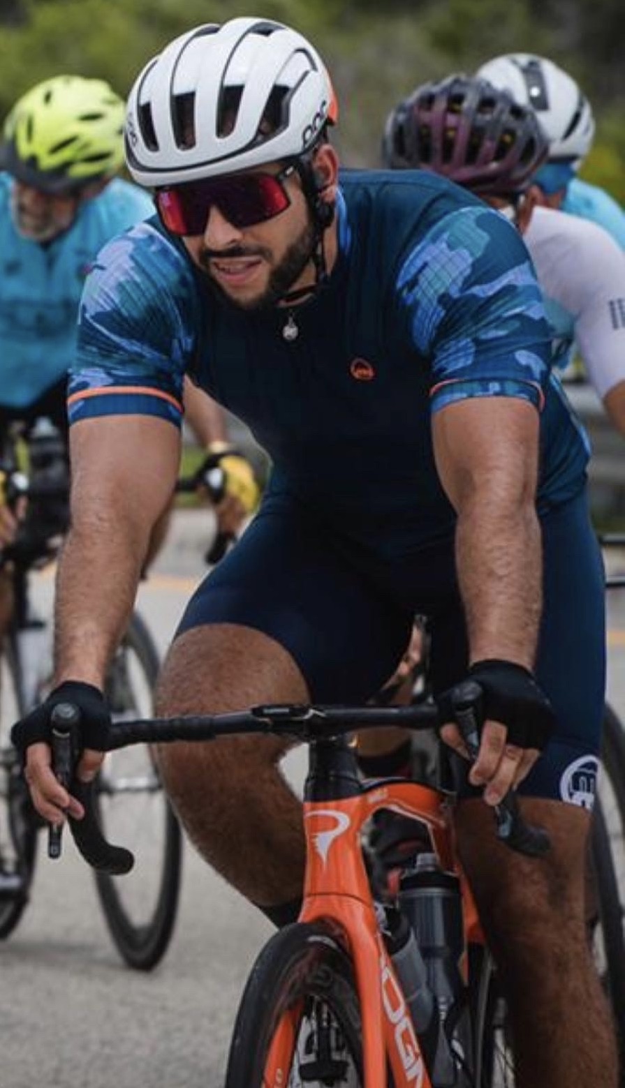 A man riding a bike with a helmet on.