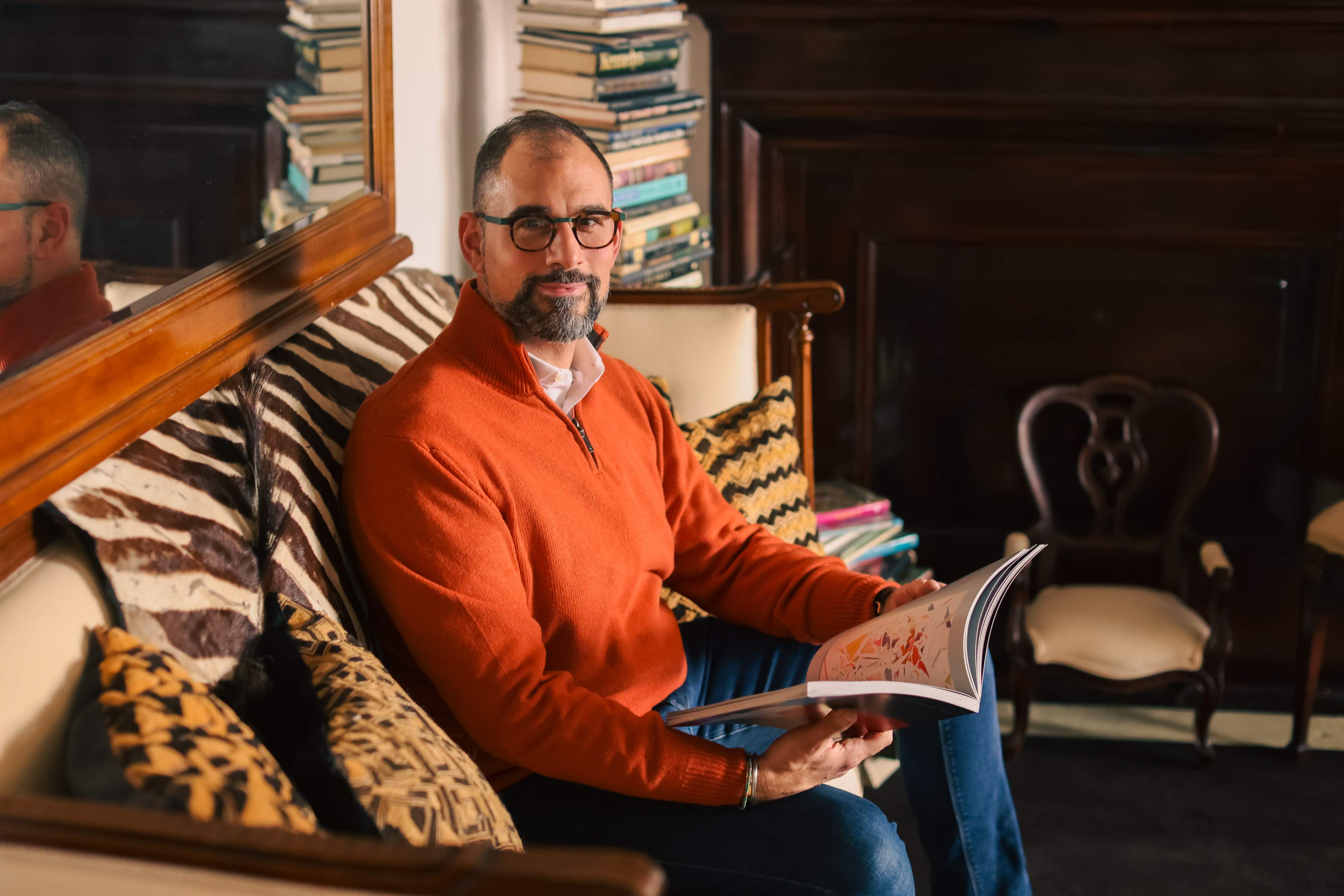 A man sitting on a couch holding a remote