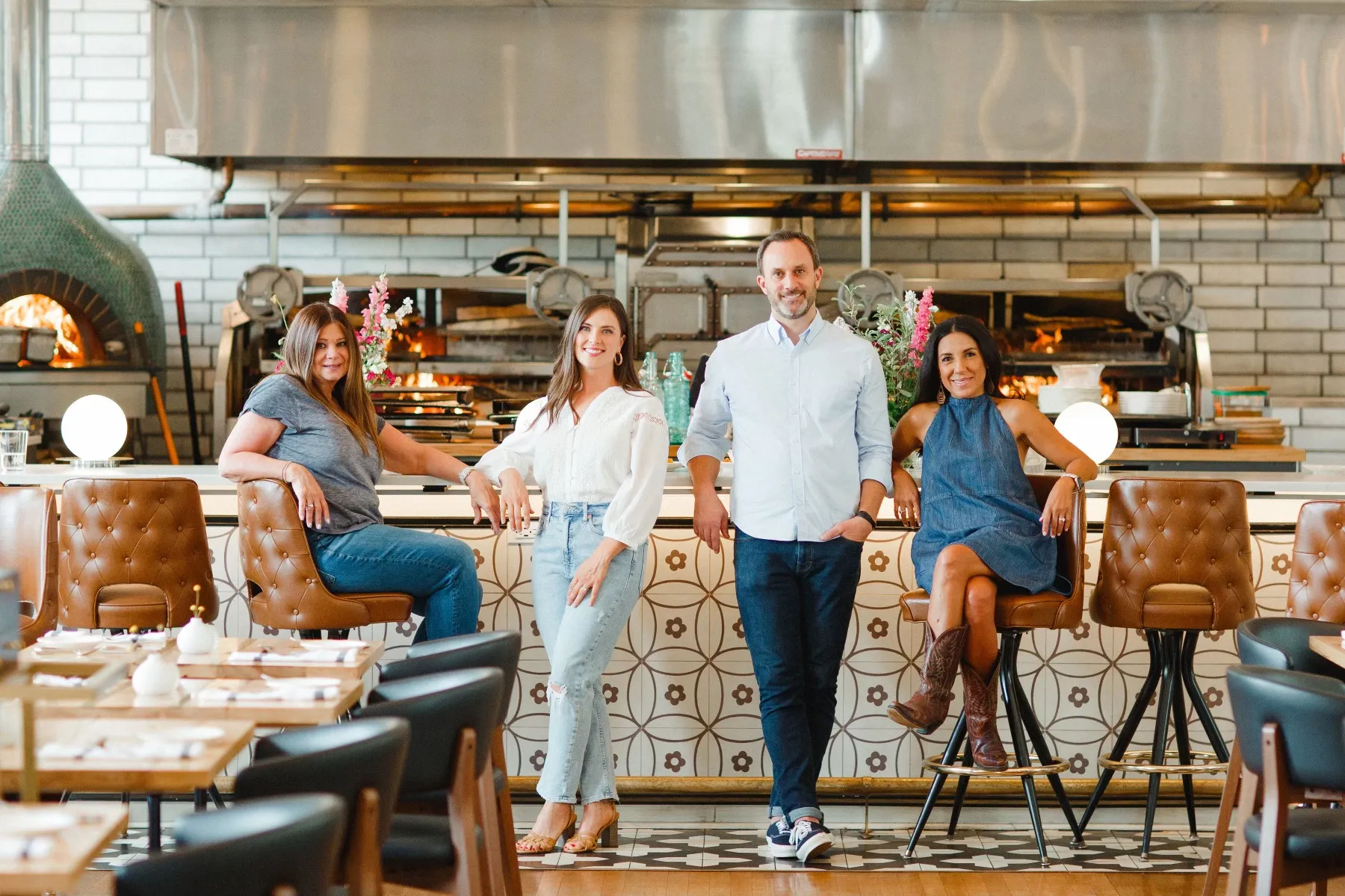 A large group of people standing around a table