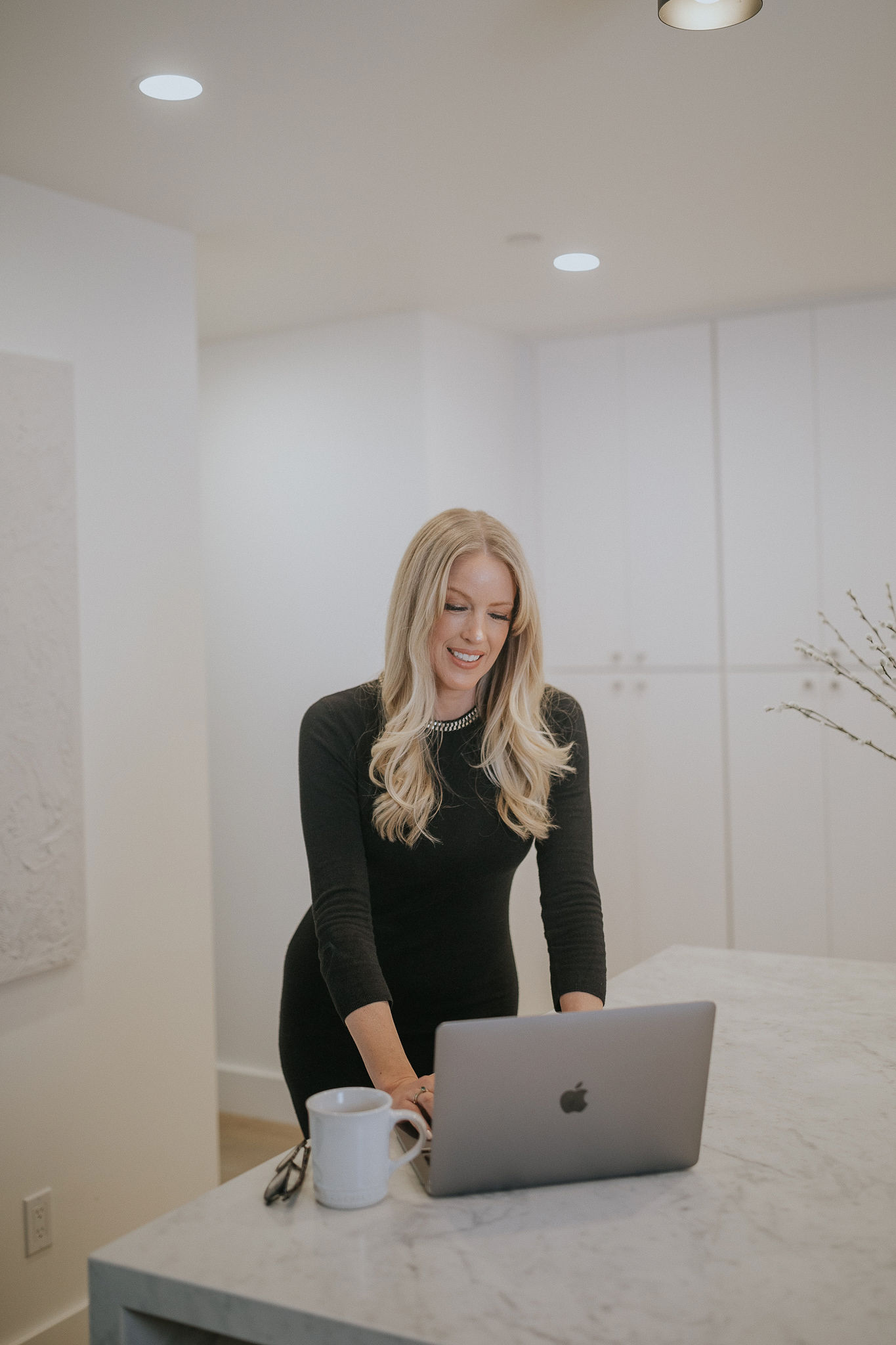 A woman sitting on a table with a laptop