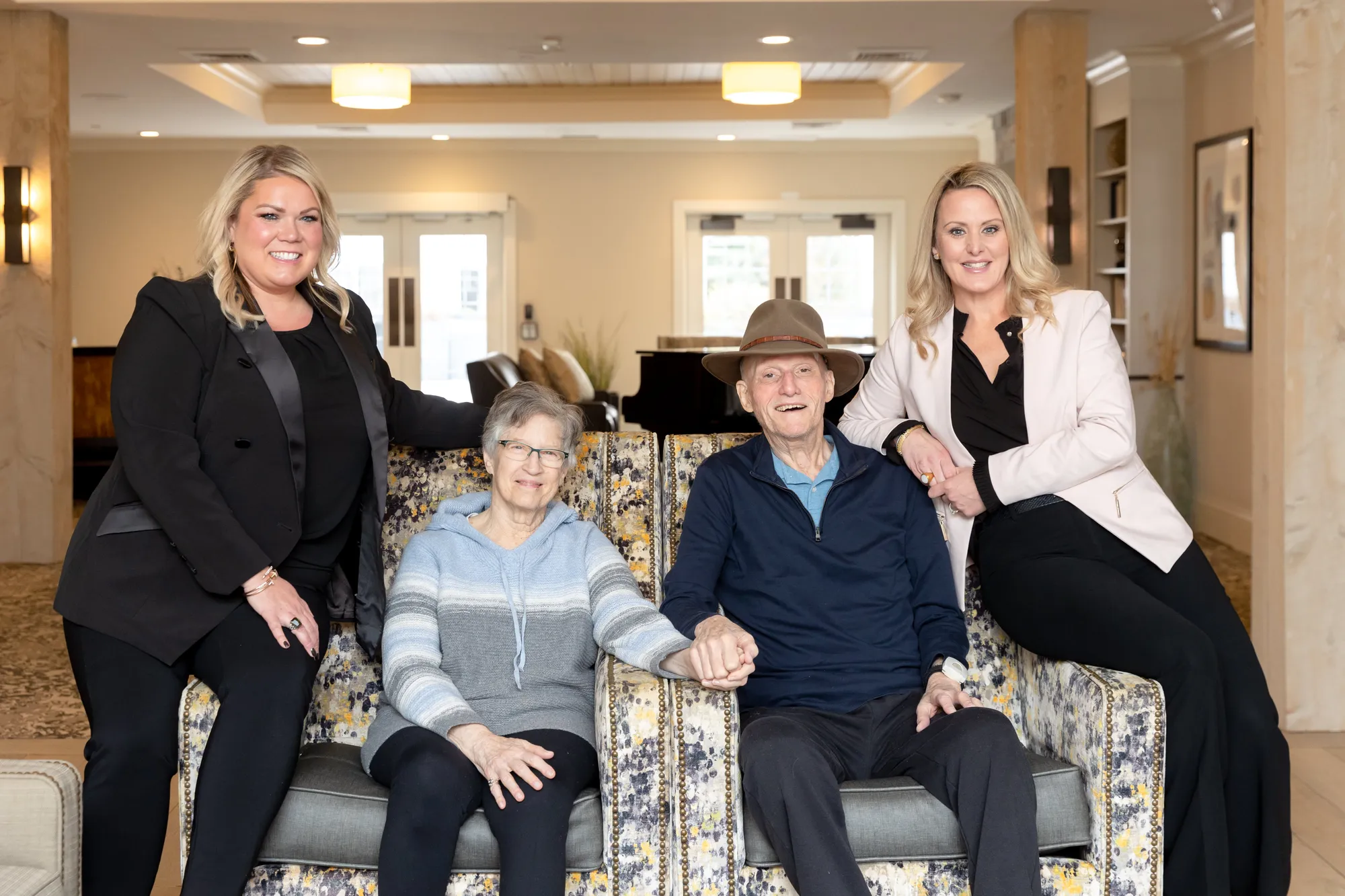 The caption for the given image is Three women sitting on a couch in a living room.