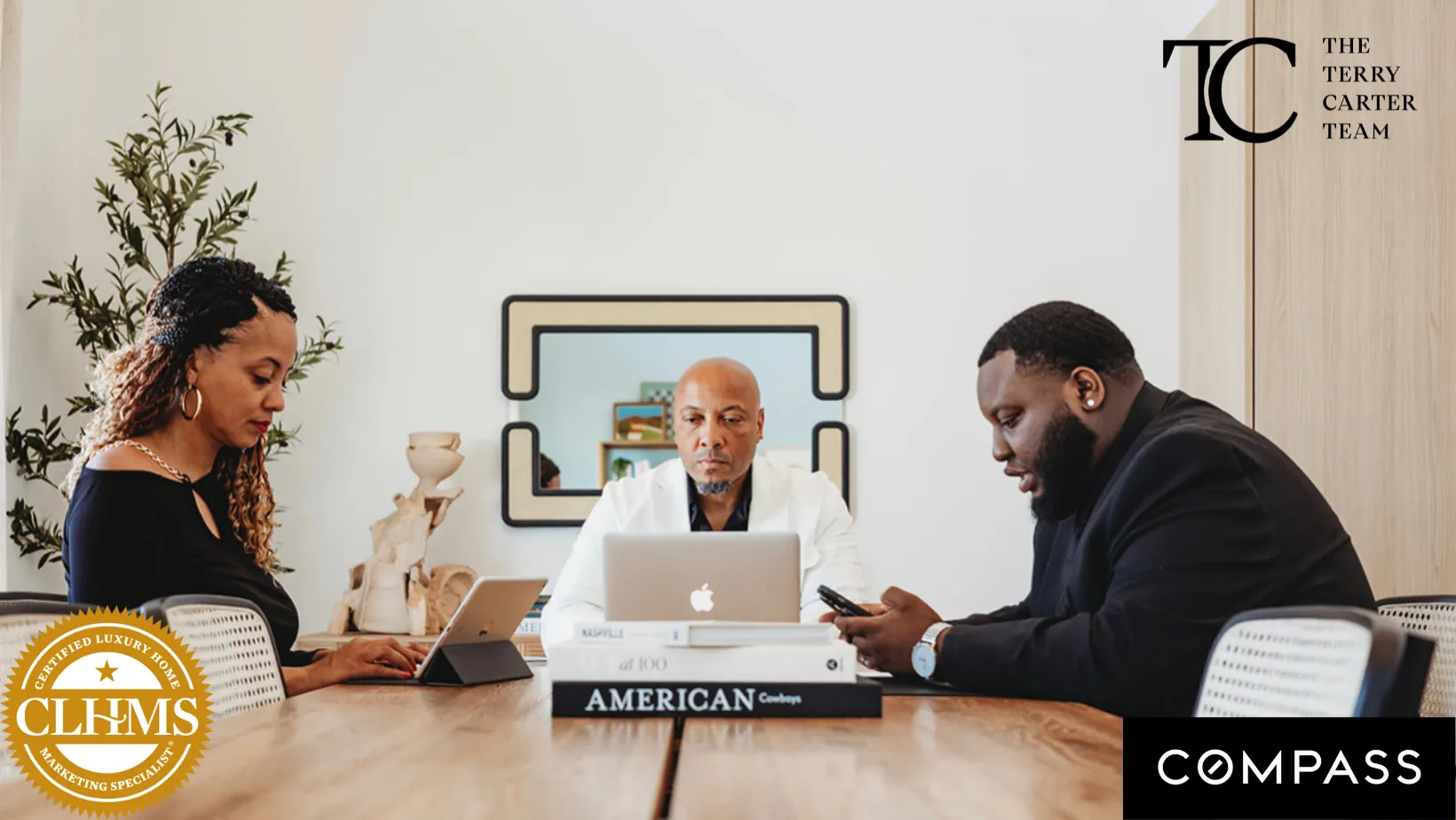 A man and woman sitting at a table with a laptop