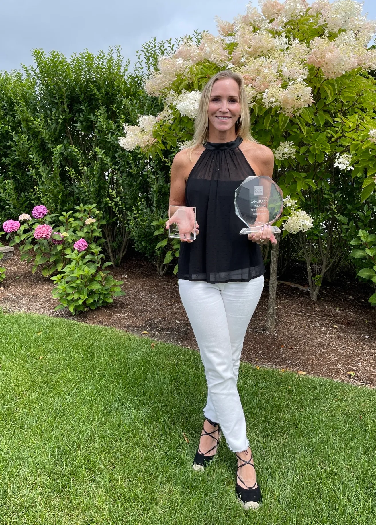Kinlin Grover Compass Awards Luncheon 2022 a woman in a dress holding a white frisbee