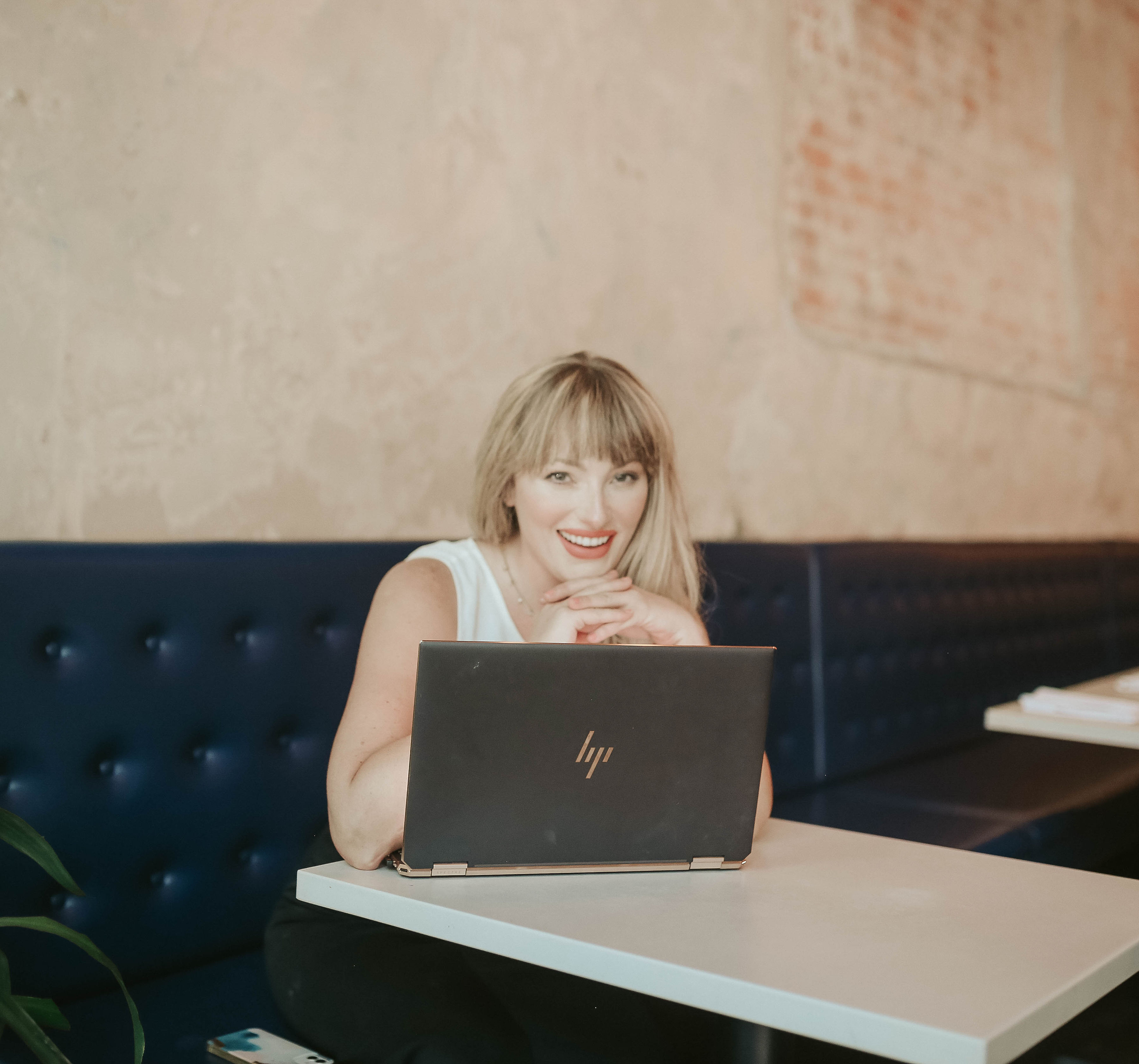 A young girl sitting on a couch using a laptop