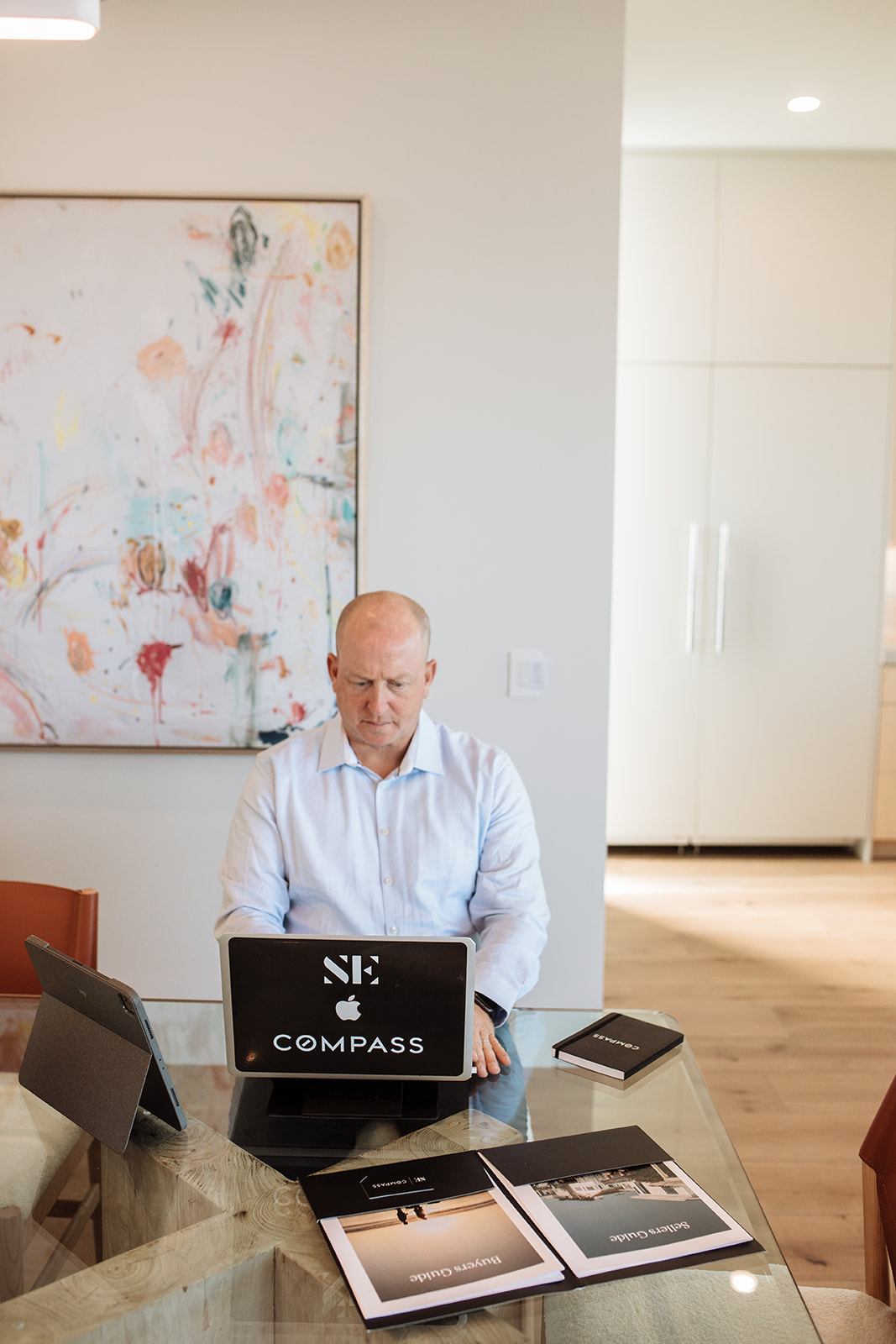 A man sitting at a table with a laptop