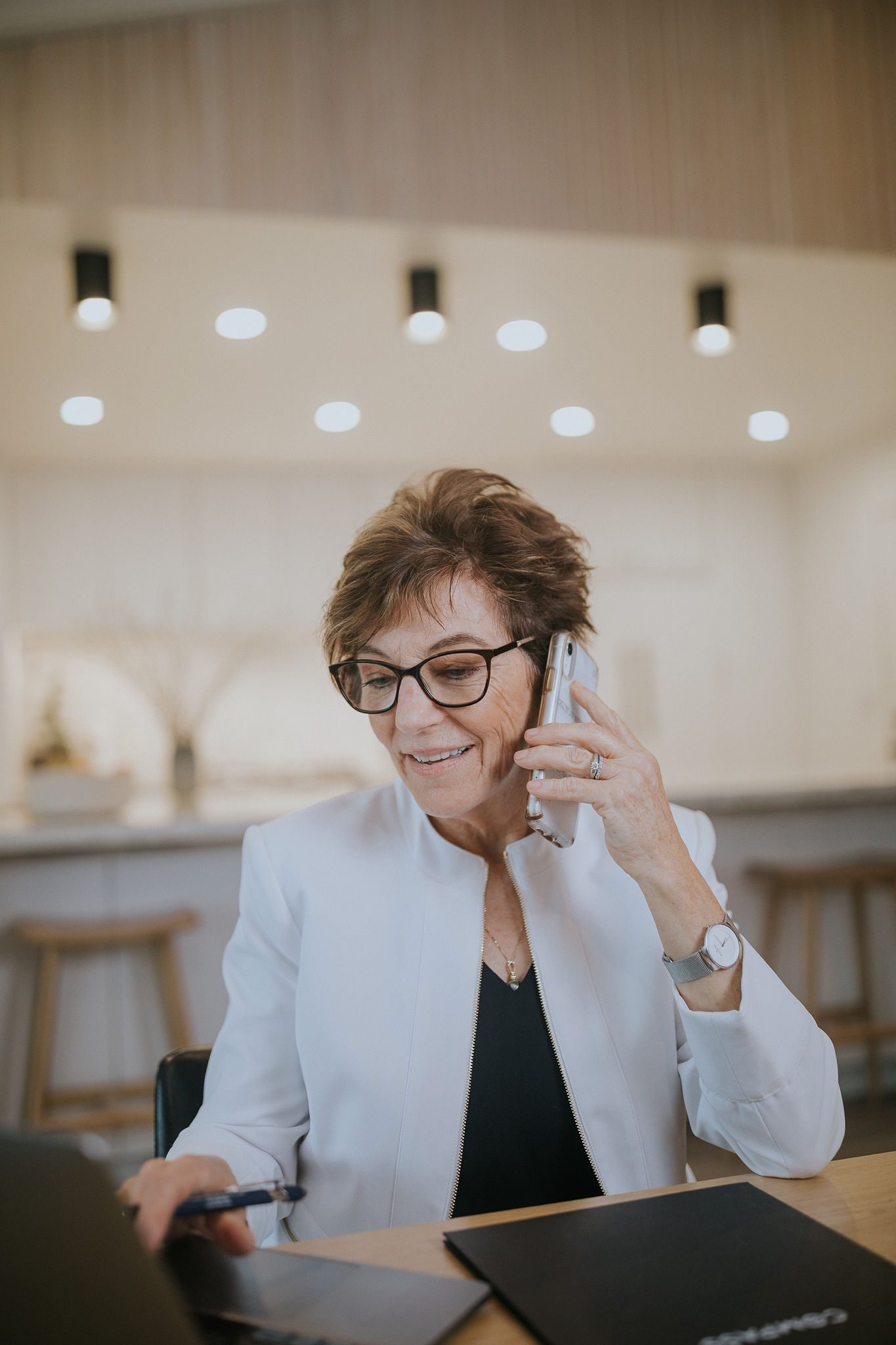 A woman in a black shirt talking on a cell phone