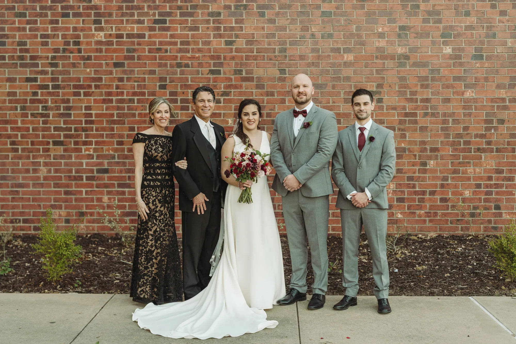 A bride and groom pose for a picture.