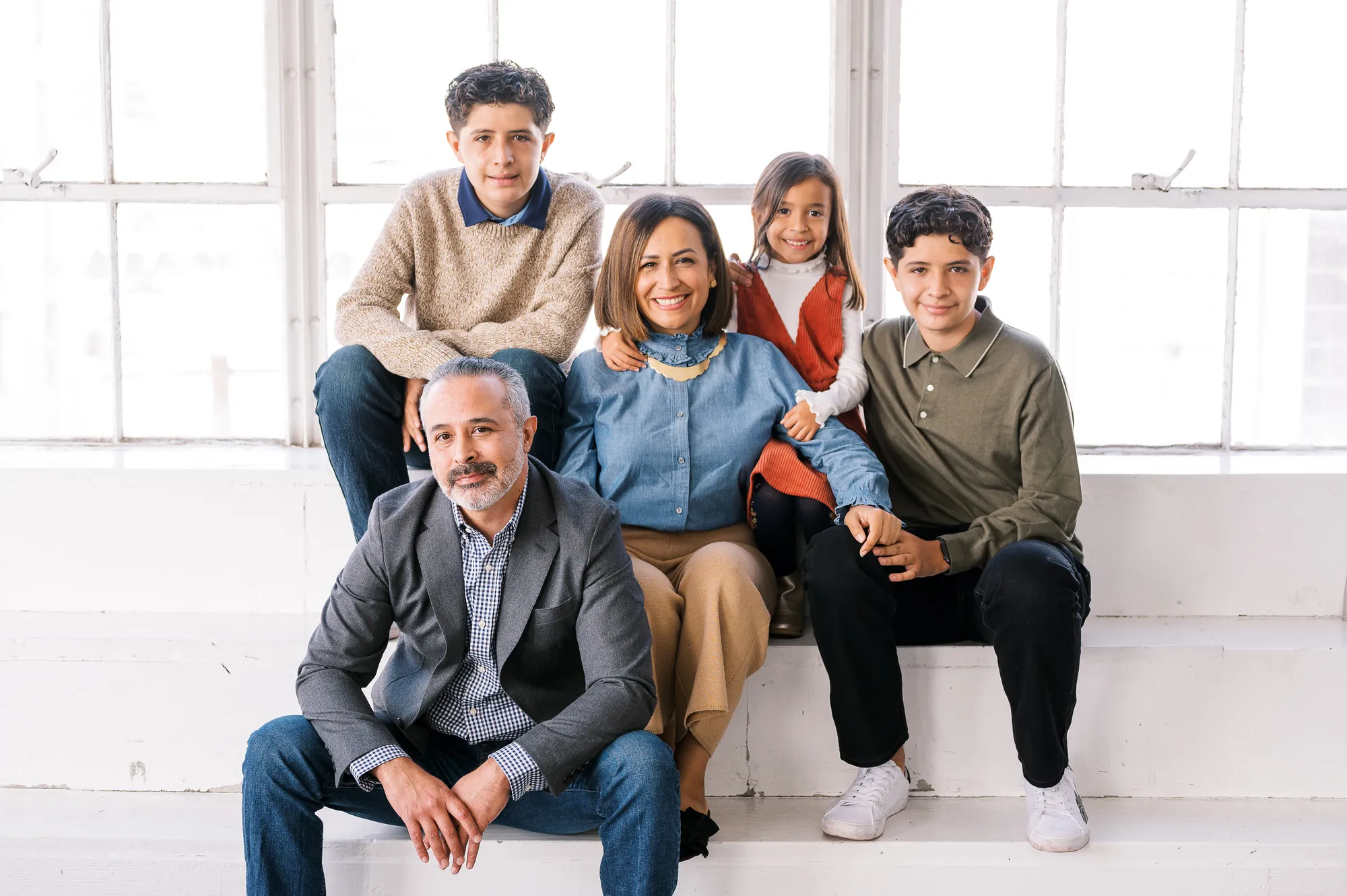 A family sitting on a bench together