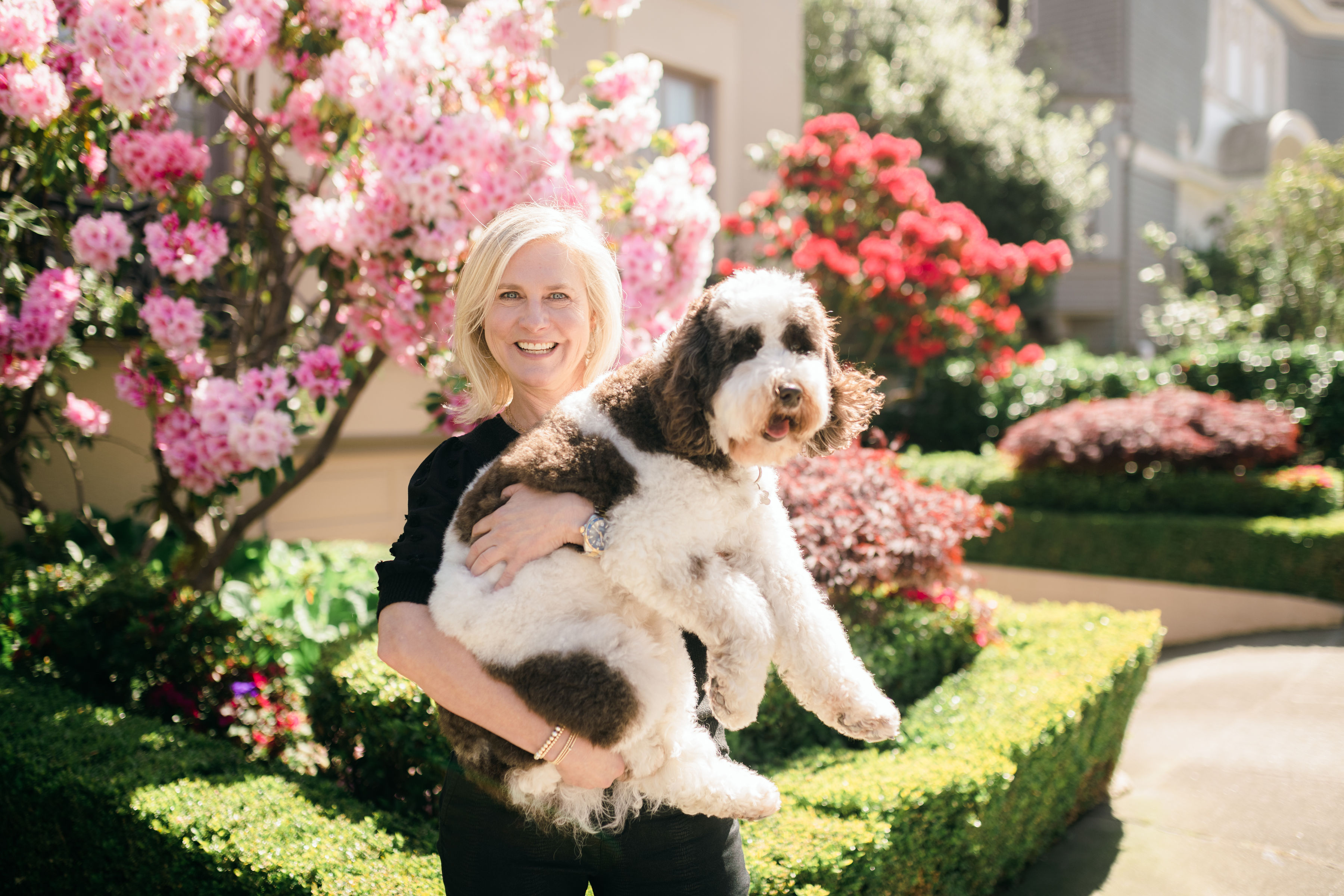 A woman holding a dog in her arms