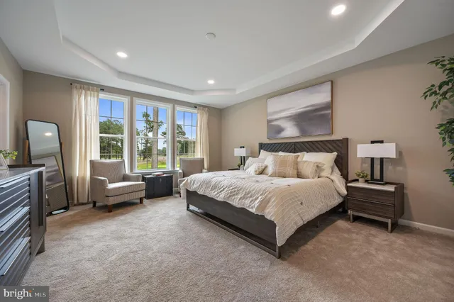 a spacious bedroom with a bed and a couch