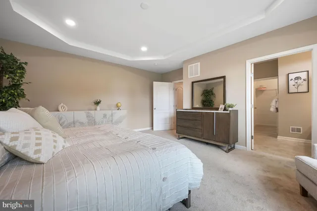 a spacious bedroom with a bed and a view of bathroom