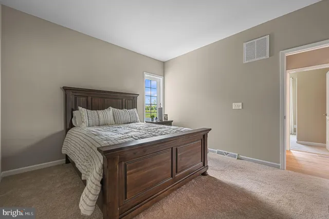 a bed sitting in a bedroom next to a window