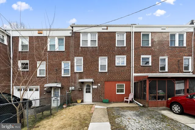 a front view of a building with a garden