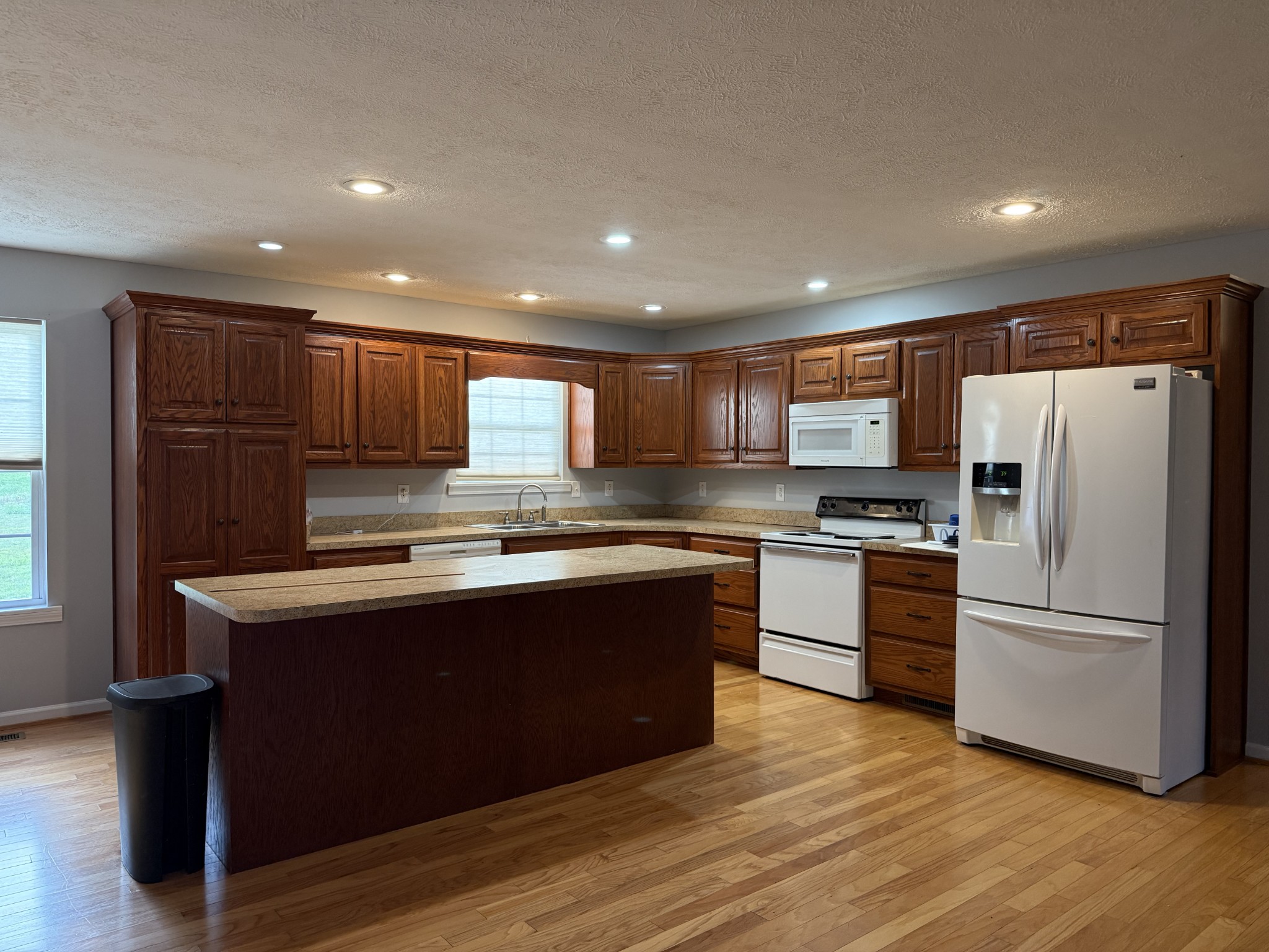 4205 Browning Branch Road Bethpage, TN 37022 - Photo 16 of 29 a kitchen with stainless steel appliances granite countertop a refrigerator a sink dishwasher a stove and a microwave oven on the wooden floor