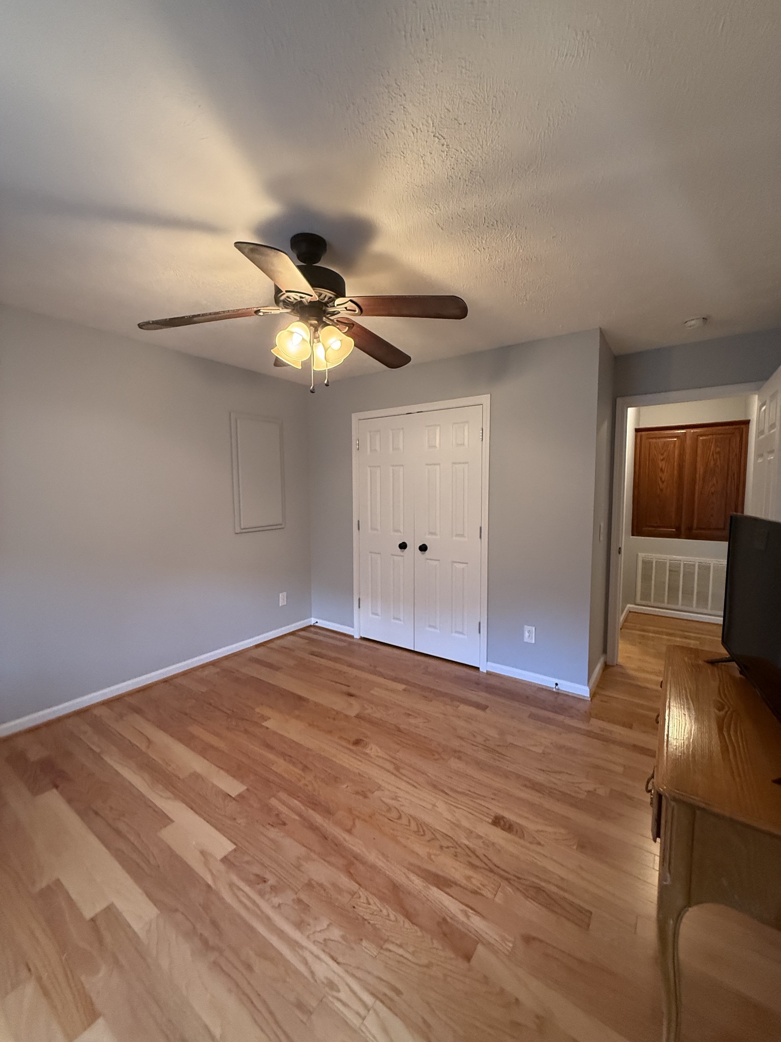 4205 Browning Branch Road Bethpage, TN 37022 - Photo 19 of 29 a view of an empty room with wooden floor and a ceiling fan