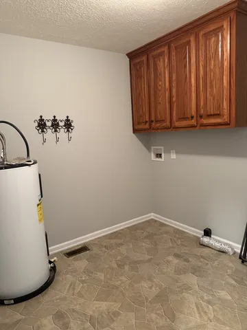 a view of a storage & utility room with a window