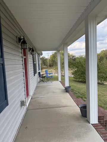 a view of a porch with wooden floor and outdoor space