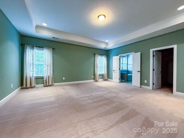 a view of a yard with plants and a brick wall