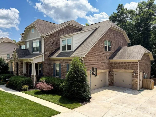 a view of a house with a yard and sitting area