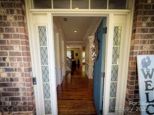 a kitchen with stainless steel appliances granite countertop wooden cabinets a refrigerator and sink