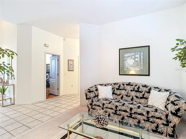 a living room with furniture a flat screen tv and a window