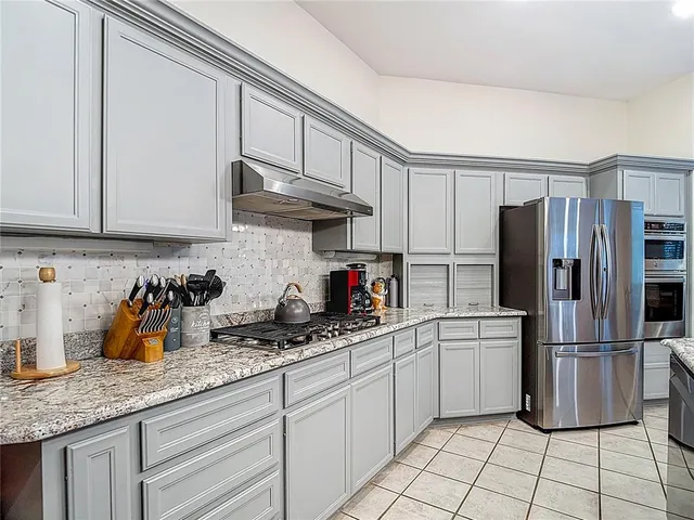 a view of walk in closet with clothes