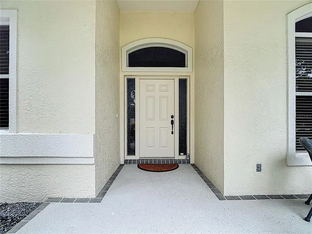 a kitchen with stainless steel appliances granite countertop a refrigerator a sink dishwasher a stove and white cabinets with wooden floor