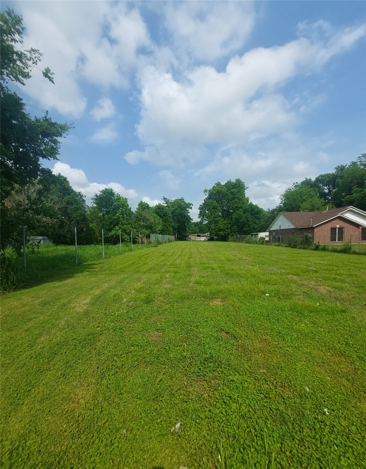 a view of a garden with a building in the background