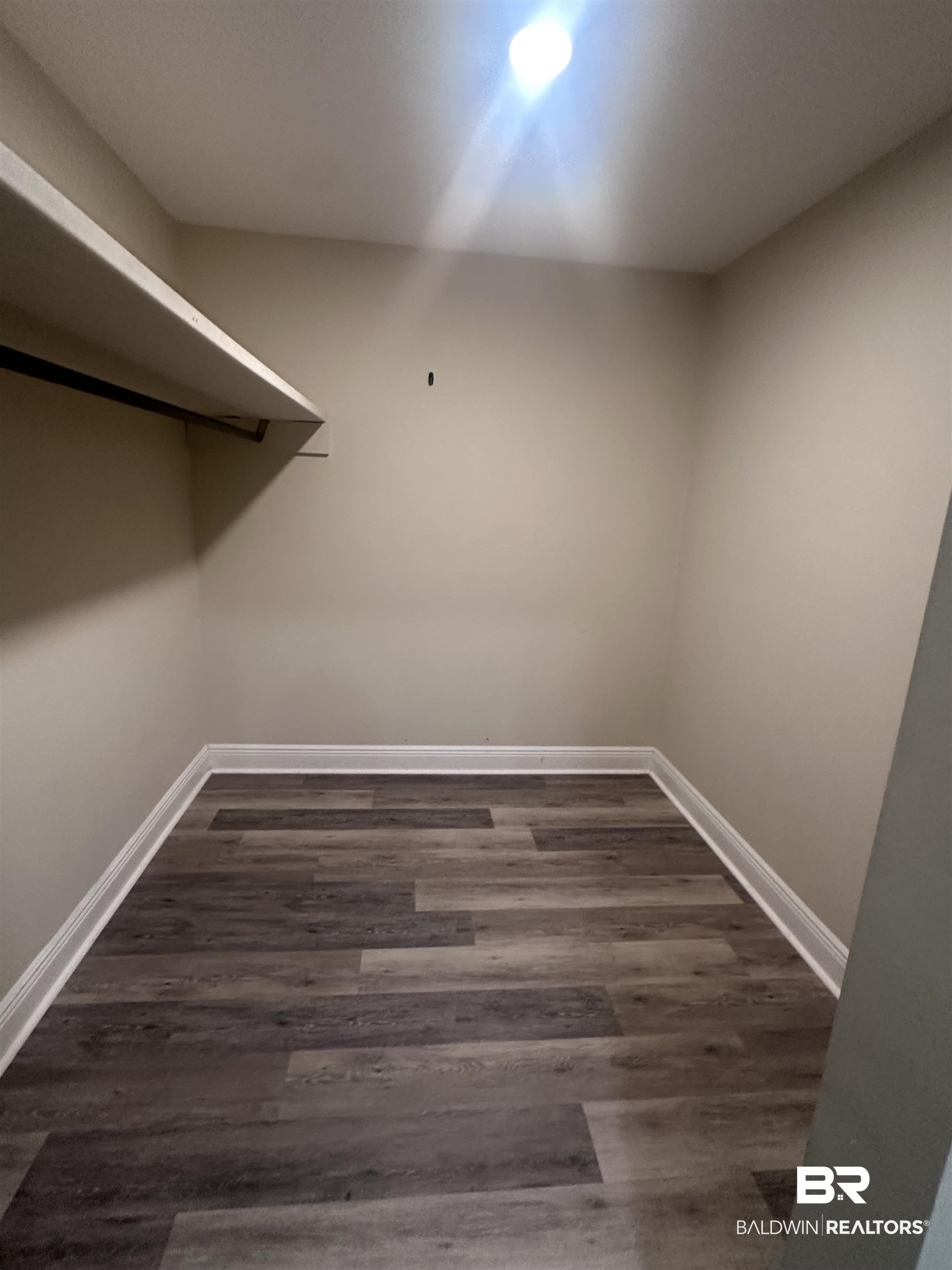 2785 Sowell Road Brewton, AL 36426 - Photo 14 of 24 Walk in closet featuring dark wood-style flooring