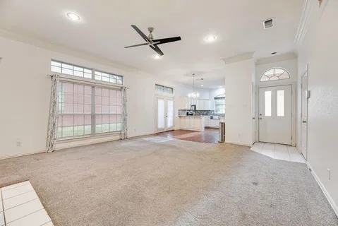 a view of empty room with wooden floor and window