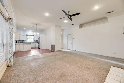 a view of empty room with wooden floor and fireplace