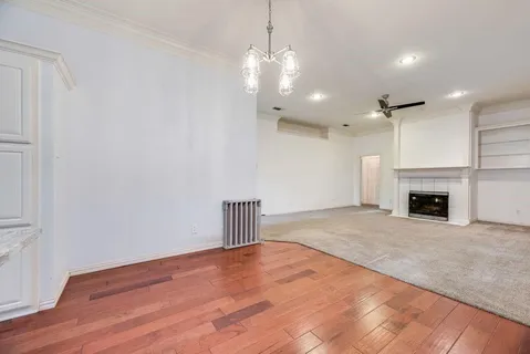 a view of a kitchen with wooden floor and a kitchen