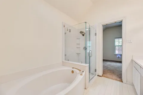 a bathroom with a bathtub and a shower