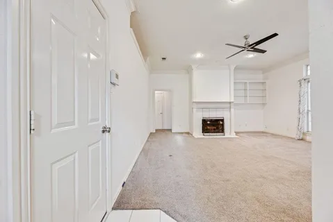 a view of a livingroom with a fireplace and window