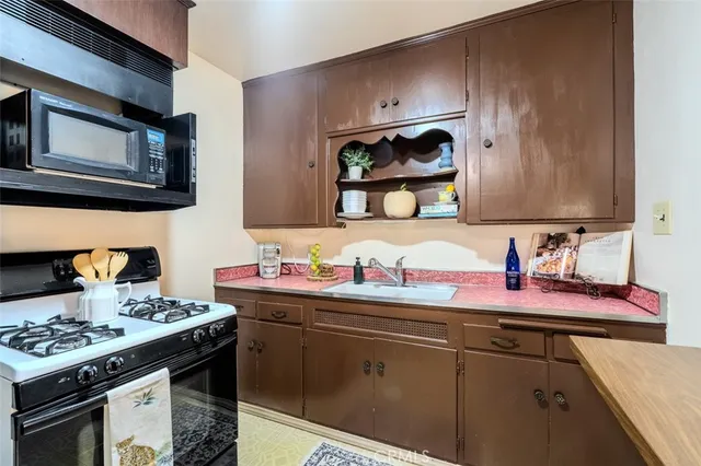 a kitchen with a stove microwave and sink