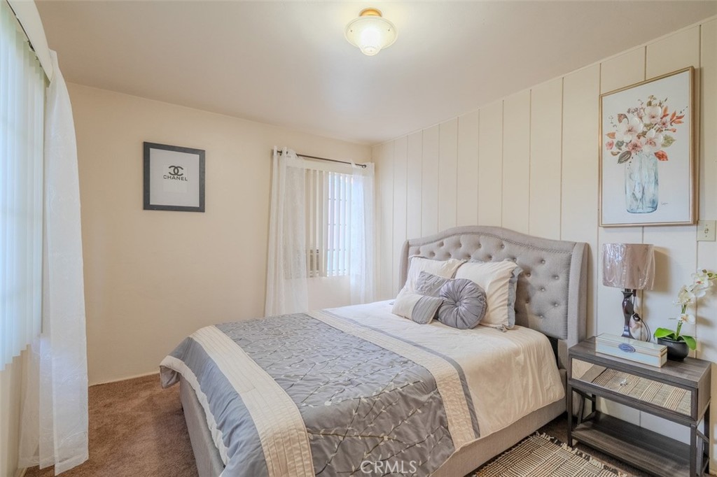 7859 Sycamore Avenue Riverside, CA 92504 - Photo 19 of 29 a bedroom with a large bed and paintings on the wall