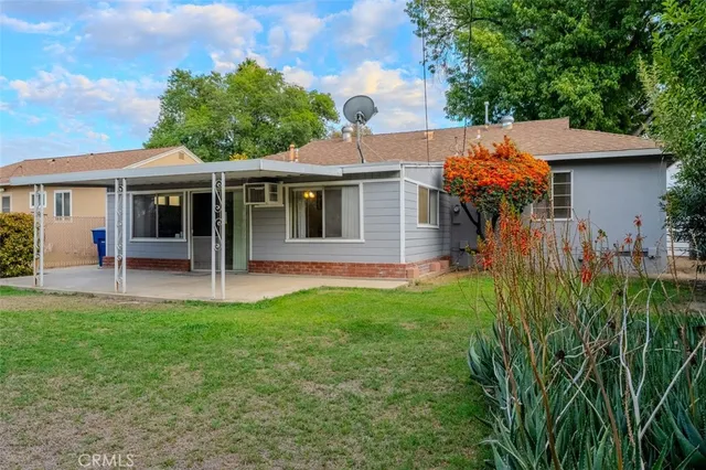 a backyard of a house with table and chairs
