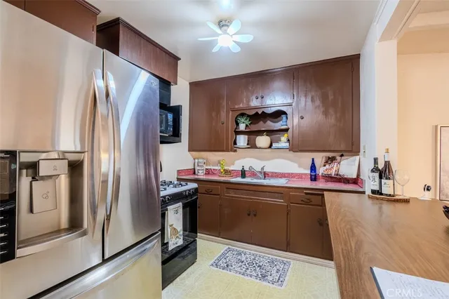 a kitchen with stainless steel appliances a sink stove and refrigerator