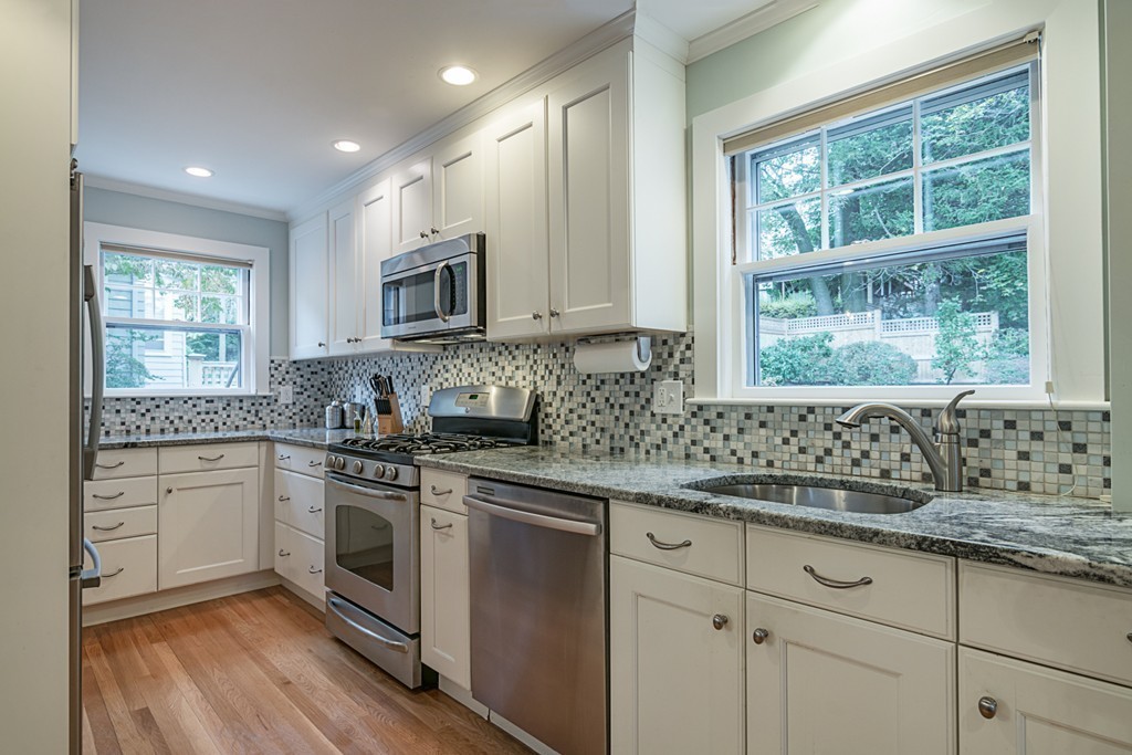 46 Allen Road Winchester, MA 01890 - Photo 12 of 29 a kitchen with granite countertop white cabinets window and stainless steel appliances