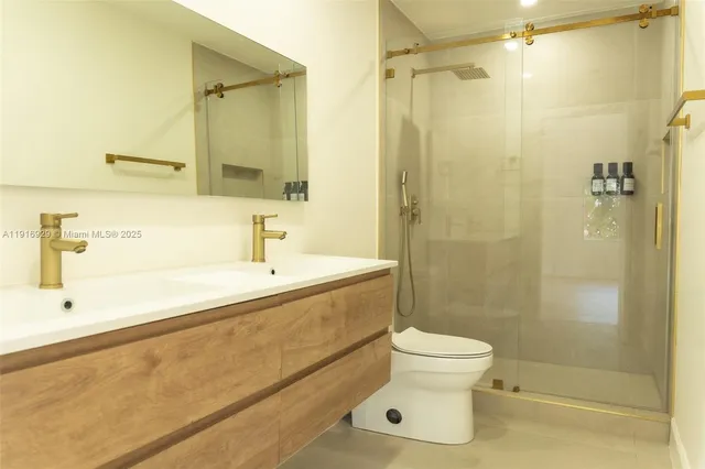 a bathroom with a sink toilet and shower