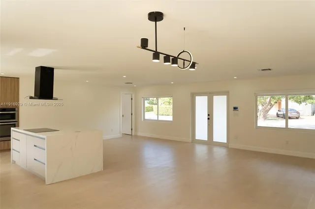 a view of a kitchen with furniture and windows