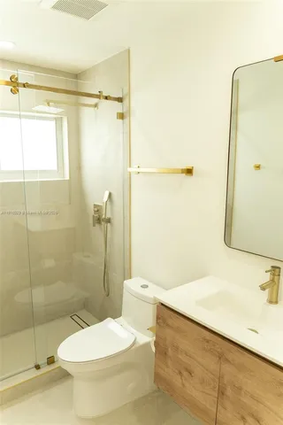 a white toilet sitting next to a bathroom sink
