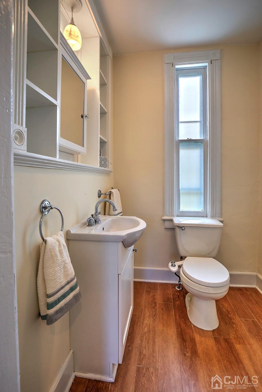321 New Market Road Dunellen, NJ 08812 - Photo 14 of 31 a bathroom with a sink toilet and a mirror